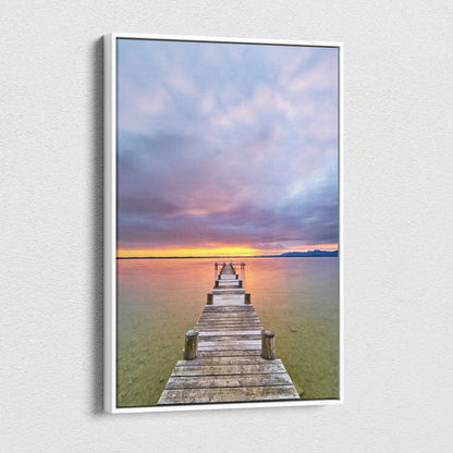 Vertical canvas wall art featuring a vibrant beach sunset with a wooden pier extending into calm water.