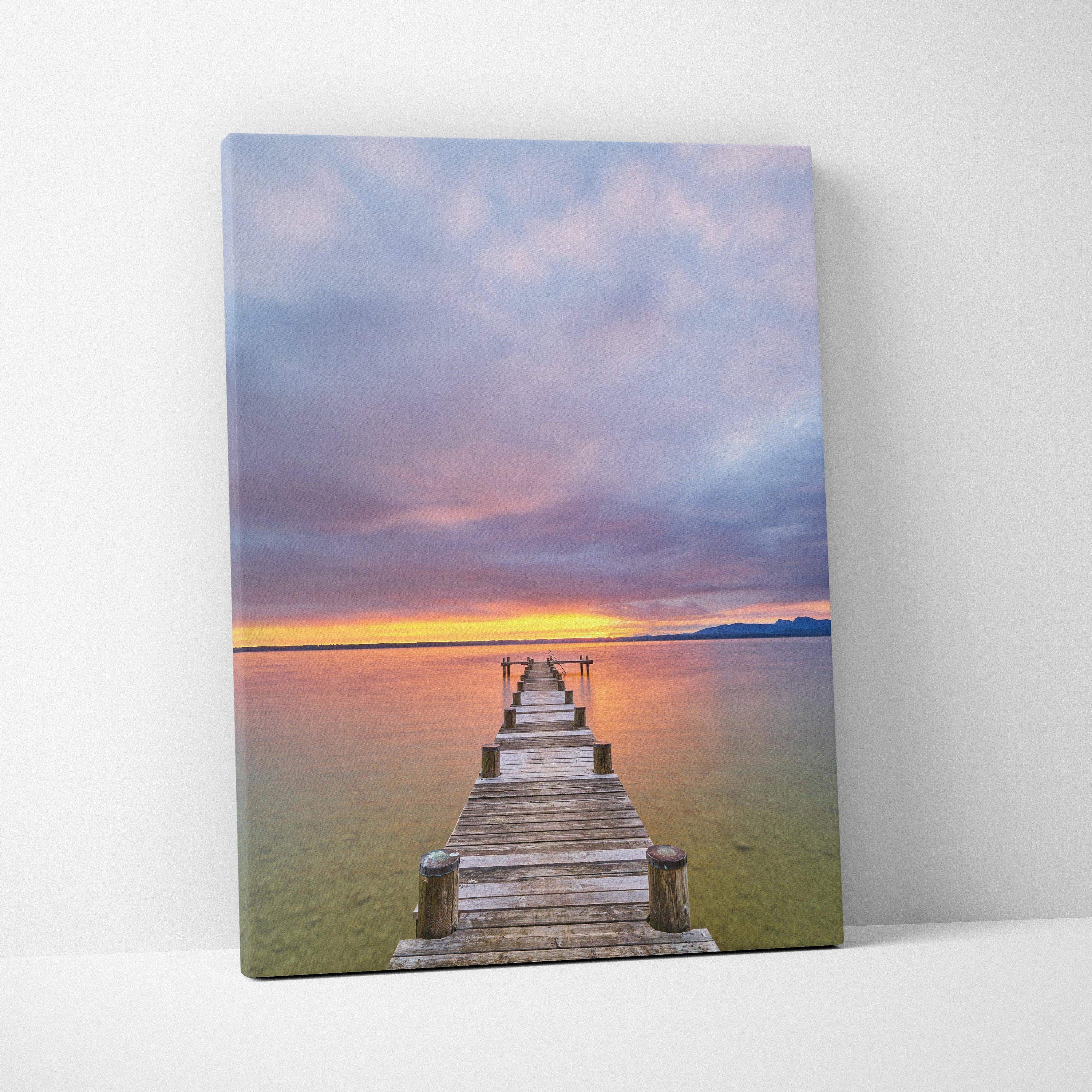 Vertical canvas wall art featuring a vibrant beach sunset with a wooden pier extending into calm water.