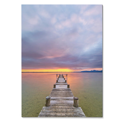 Vertical poster of a wooden pier extending into calm ocean waters under a vibrant sunset sky wall art.