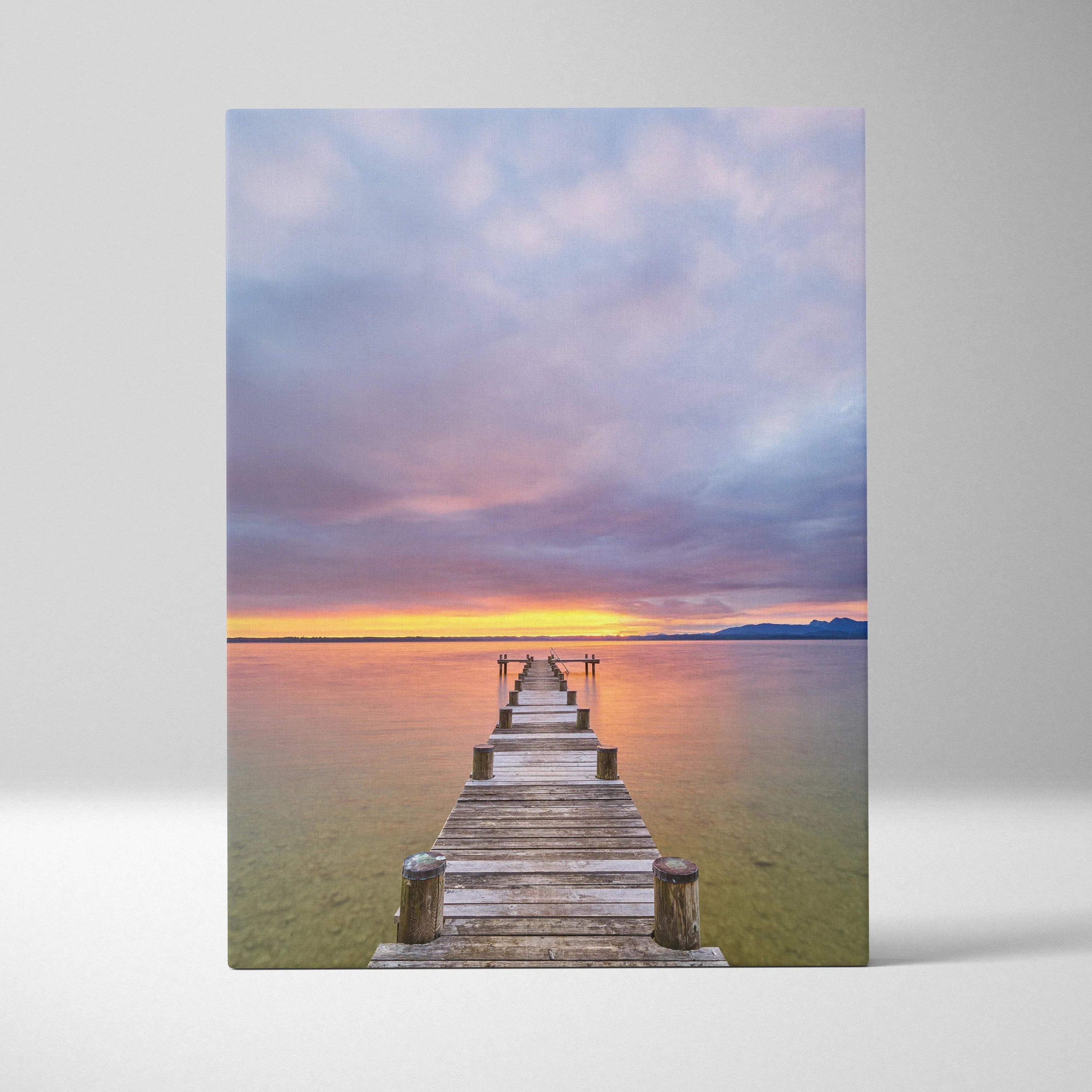 Vertical canvas wall art featuring a vibrant beach sunset with a wooden pier extending into calm water.