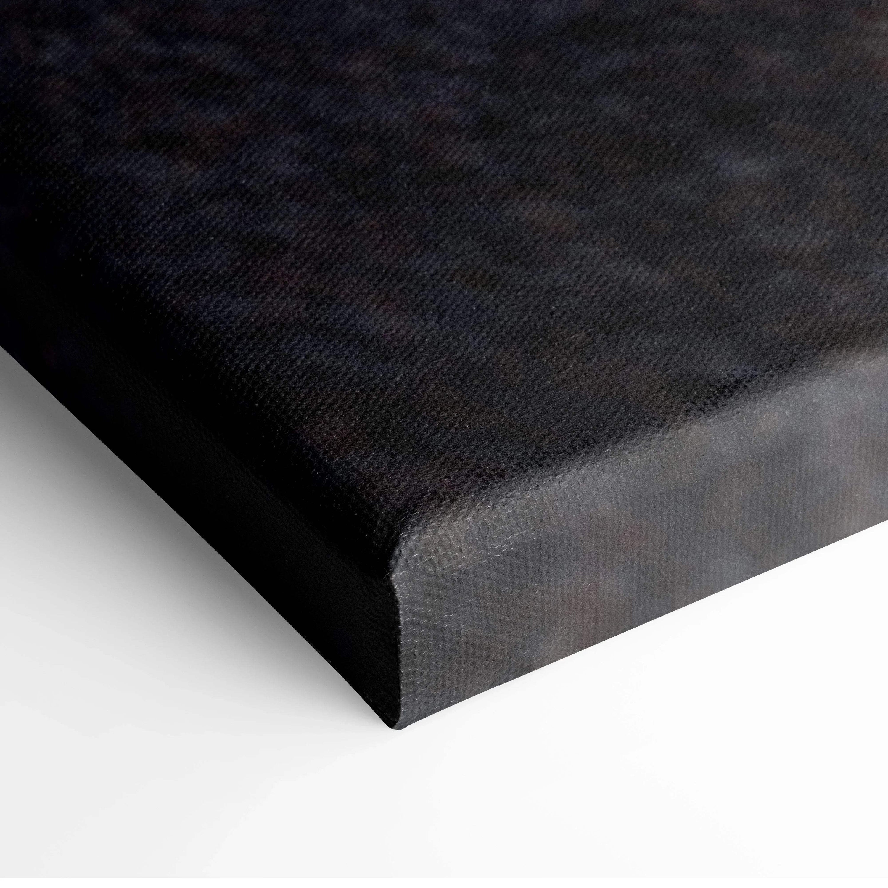 Close-up of black wraparound edge on canvas wall art print with textured surface.