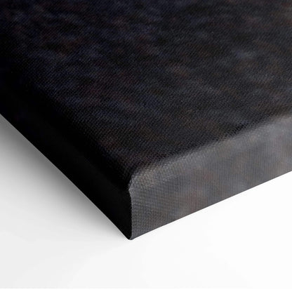 Close-up of black wraparound edge on canvas wall art print with textured surface.