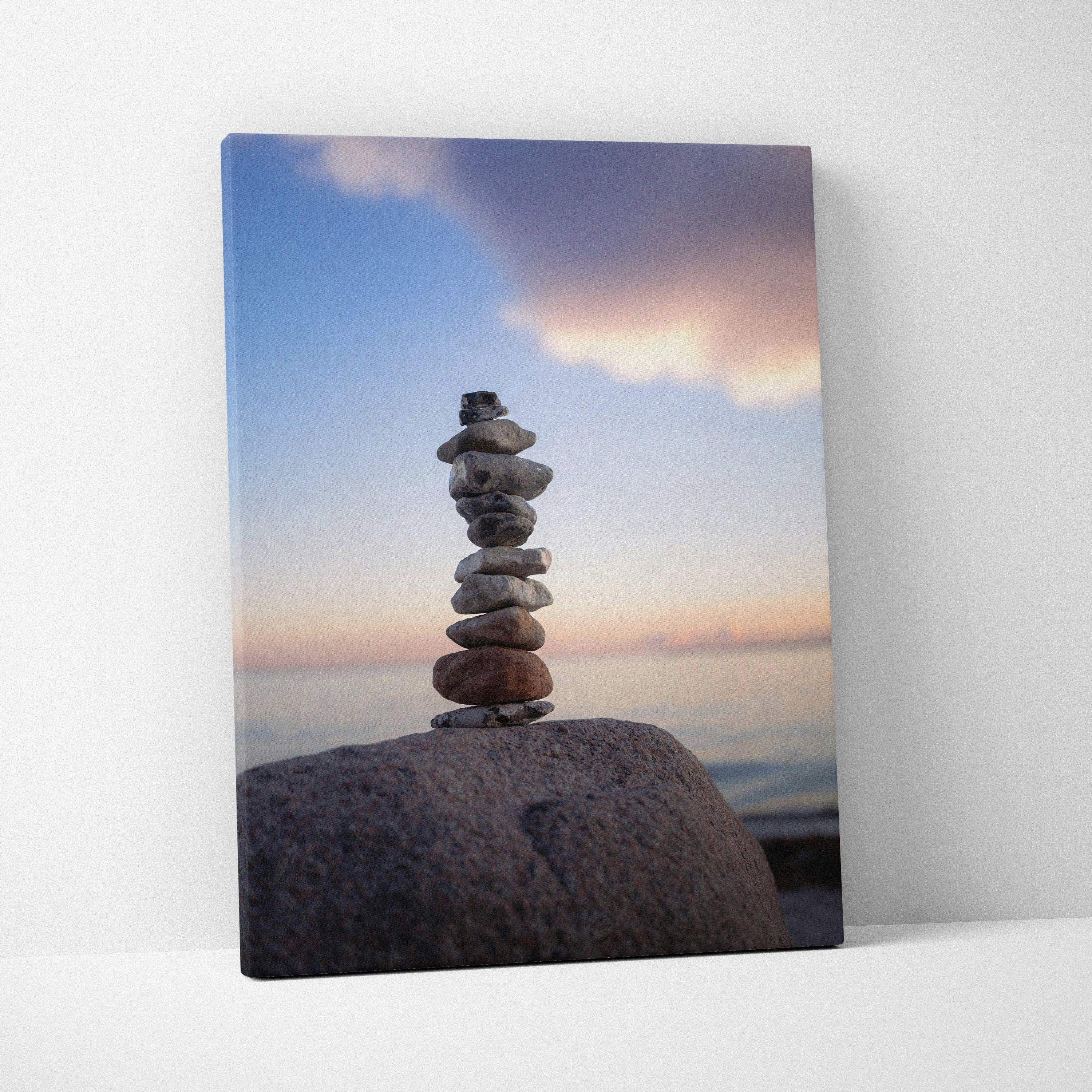 Canvas wall art featuring balanced beach stones at sunset with soft pastel sky colors.