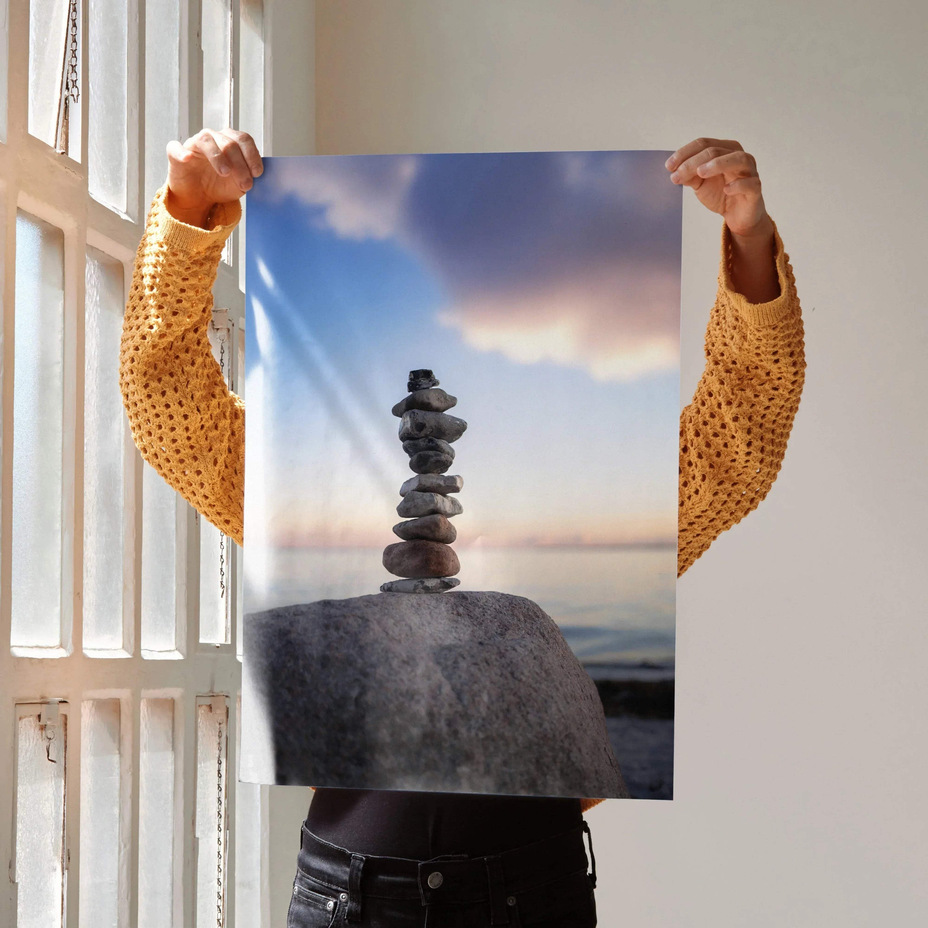Serene nature wall art poster featuring balanced stones on rock with cloudy sky background.