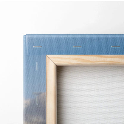 Close-up of canvas wall art corner with natural wood frame and blue printed fabric wrapping.