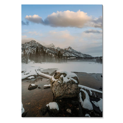 Vertical poster of snowy mountain peaks above a misty lake with rocks, wall art, nature art.