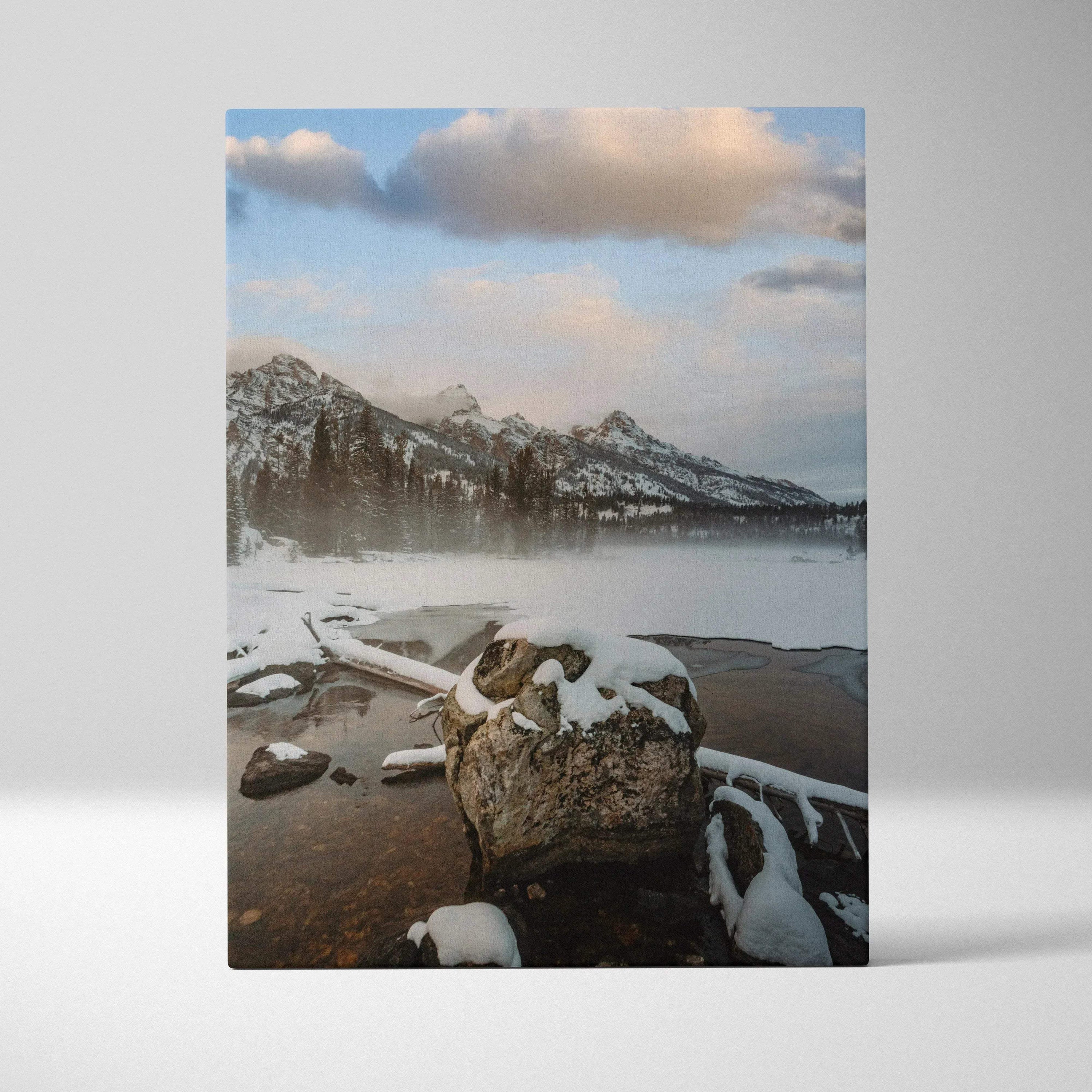 Vertical canvas wall art featuring snow-capped mountains with misty lake and rocks in foreground.