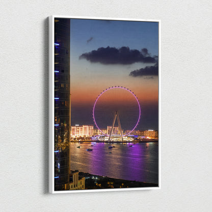 Vertical canvas wall art featuring a vibrant sunset cityscape with a lit Ferris wheel over water.