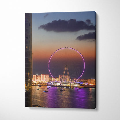 Vertical canvas wall art featuring a vibrant sunset cityscape with illuminated Ferris wheel and waterfront buildings.