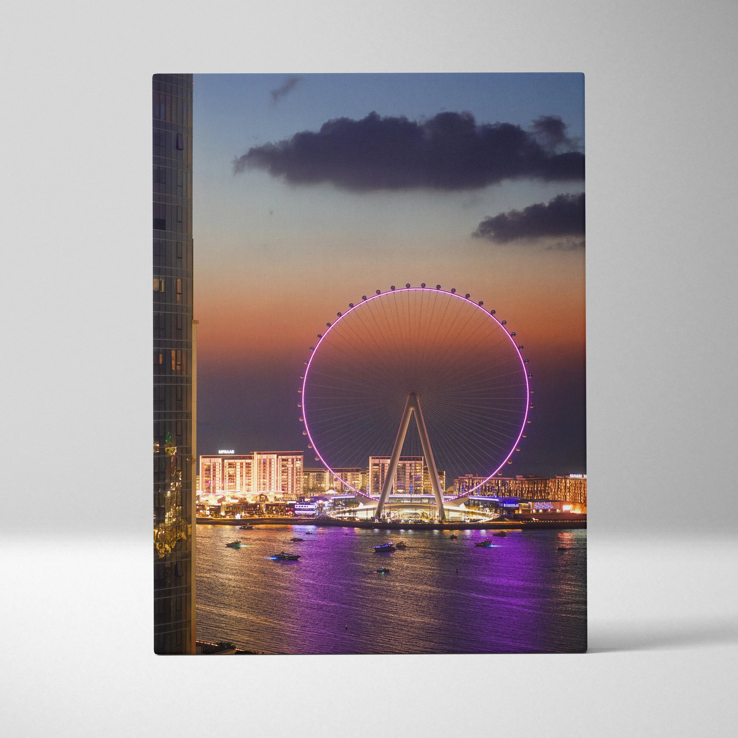 Sunset cityscape canvas wall art featuring a glowing Ferris wheel and illuminated buildings over water.