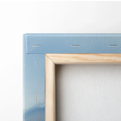 Corner close-up of vibrant city sunset canvas wall art with natural wood frame and blue stretched fabric backing.