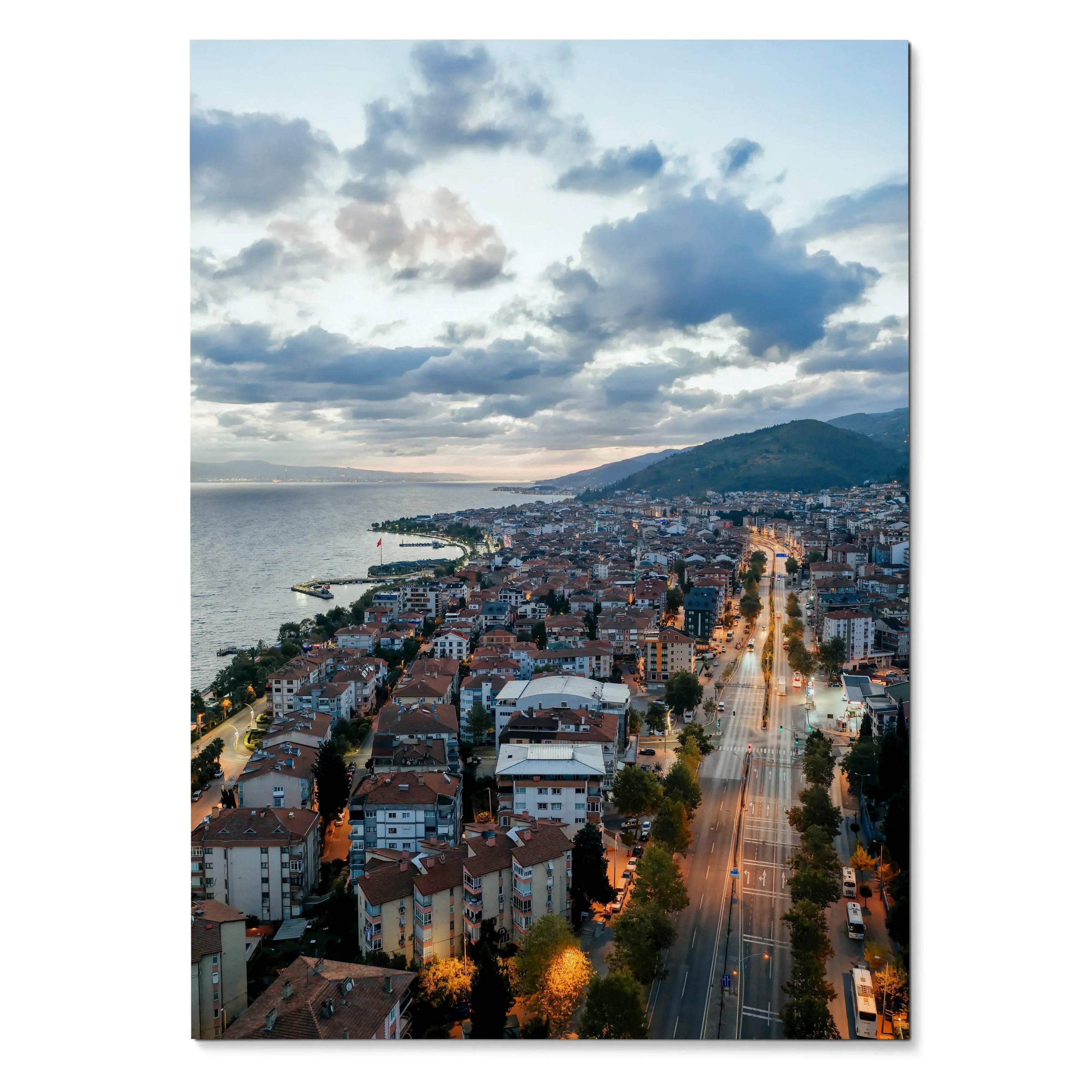Vertical cityscape poster featuring a vibrant sunset over coastal buildings and streets, wall art with dramatic clouds.