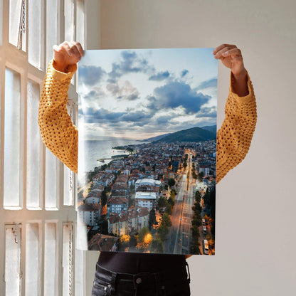 Vertical vibrant city sunset poster featuring glowing streetlights and dramatic clouds for wall art.