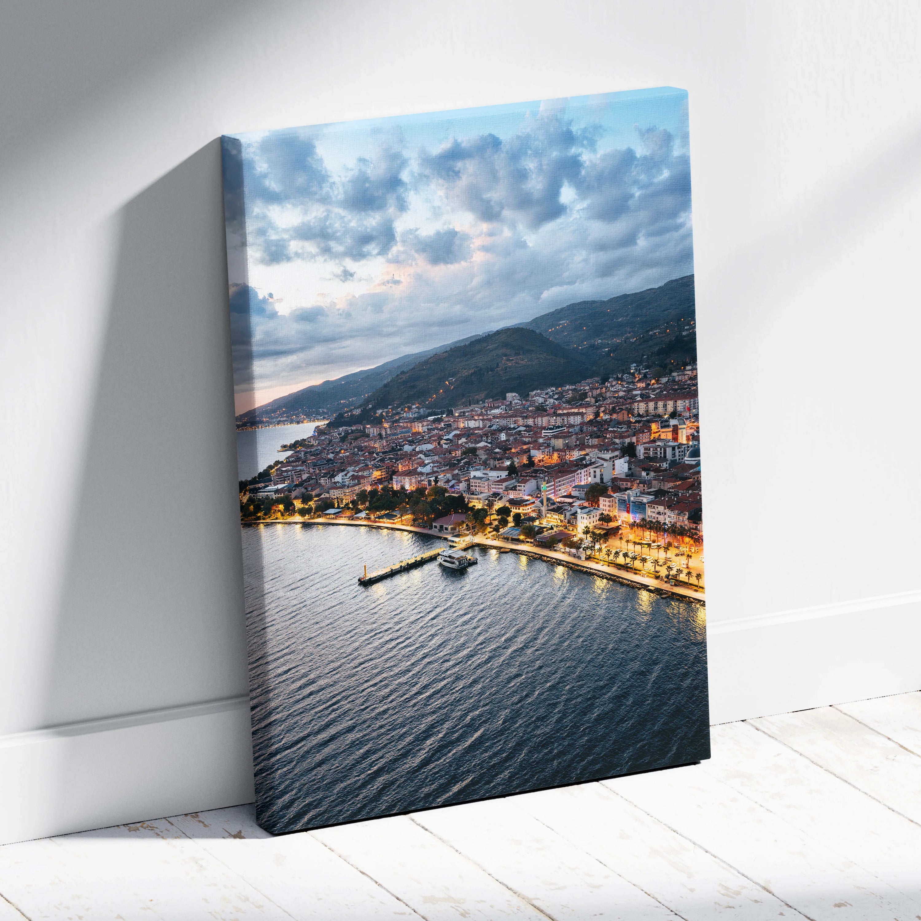 Canvas wall art featuring a vibrant city sunset over a coastal harbor with buildings and mountains.