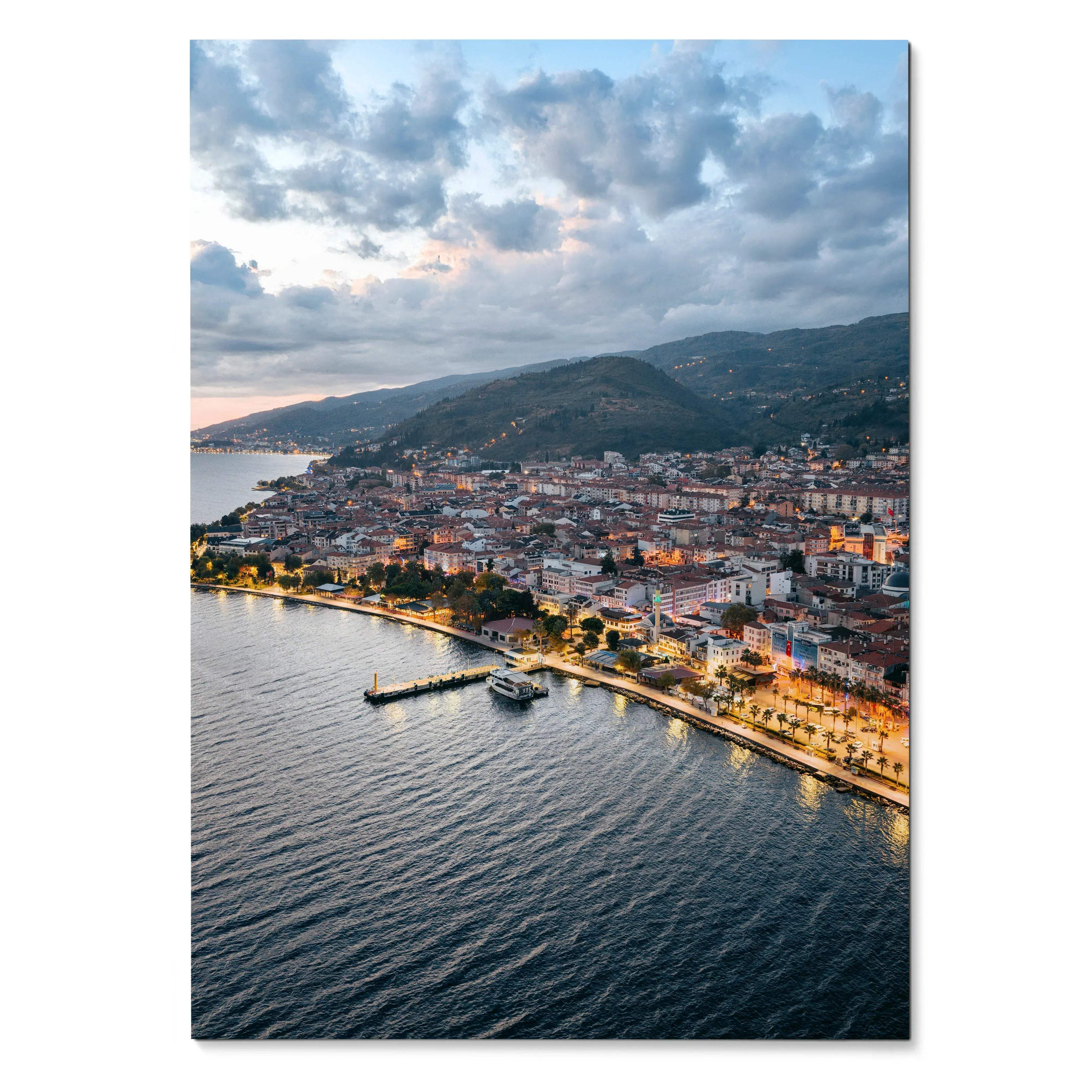 Vertical cityscape poster featuring a sunset sky over coastal buildings and waterfront wall art.