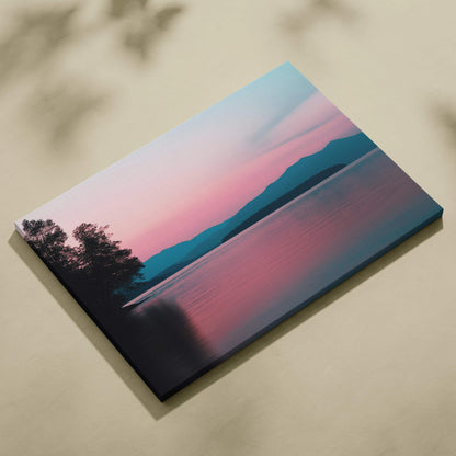 Canvas print of serene sunset over still lake with silhouetted mountains in pink blue tones