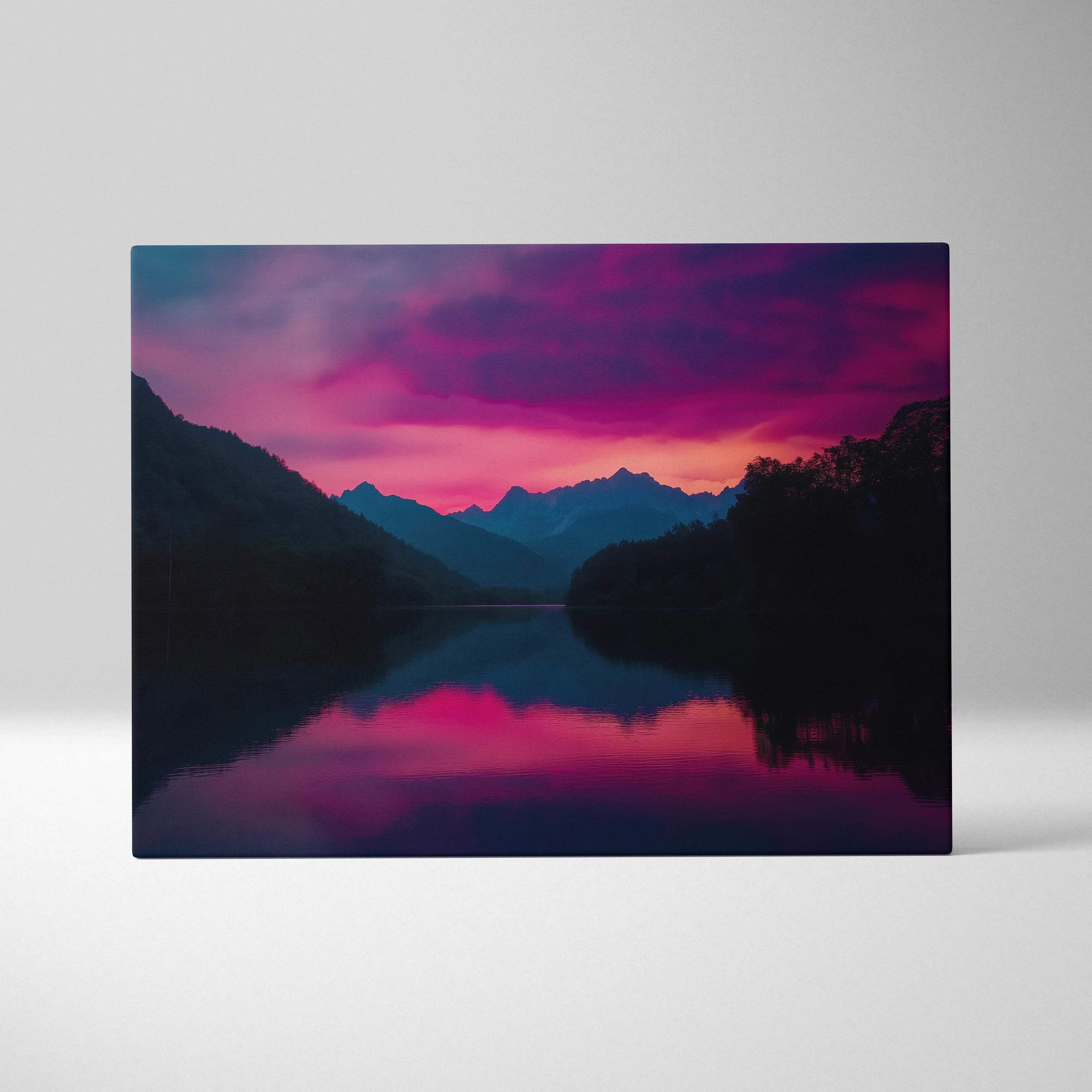 Vibrant pink purple sunset canvas print with silhouetted mountains reflected in calm lake