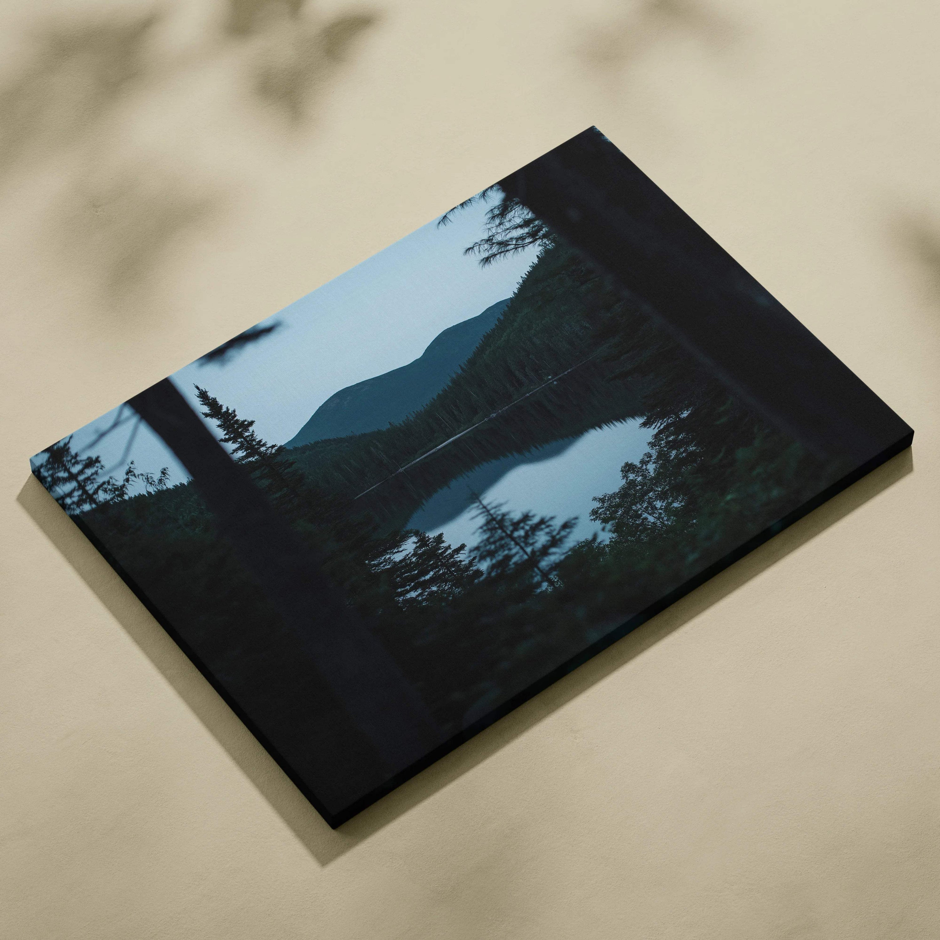 Black canvas print of serene mountain lake with evergreens at blue hour