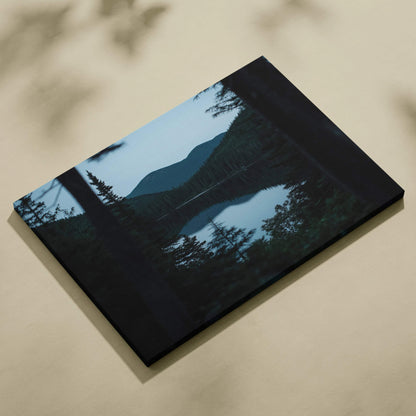 Black canvas print of serene mountain lake with evergreens at blue hour