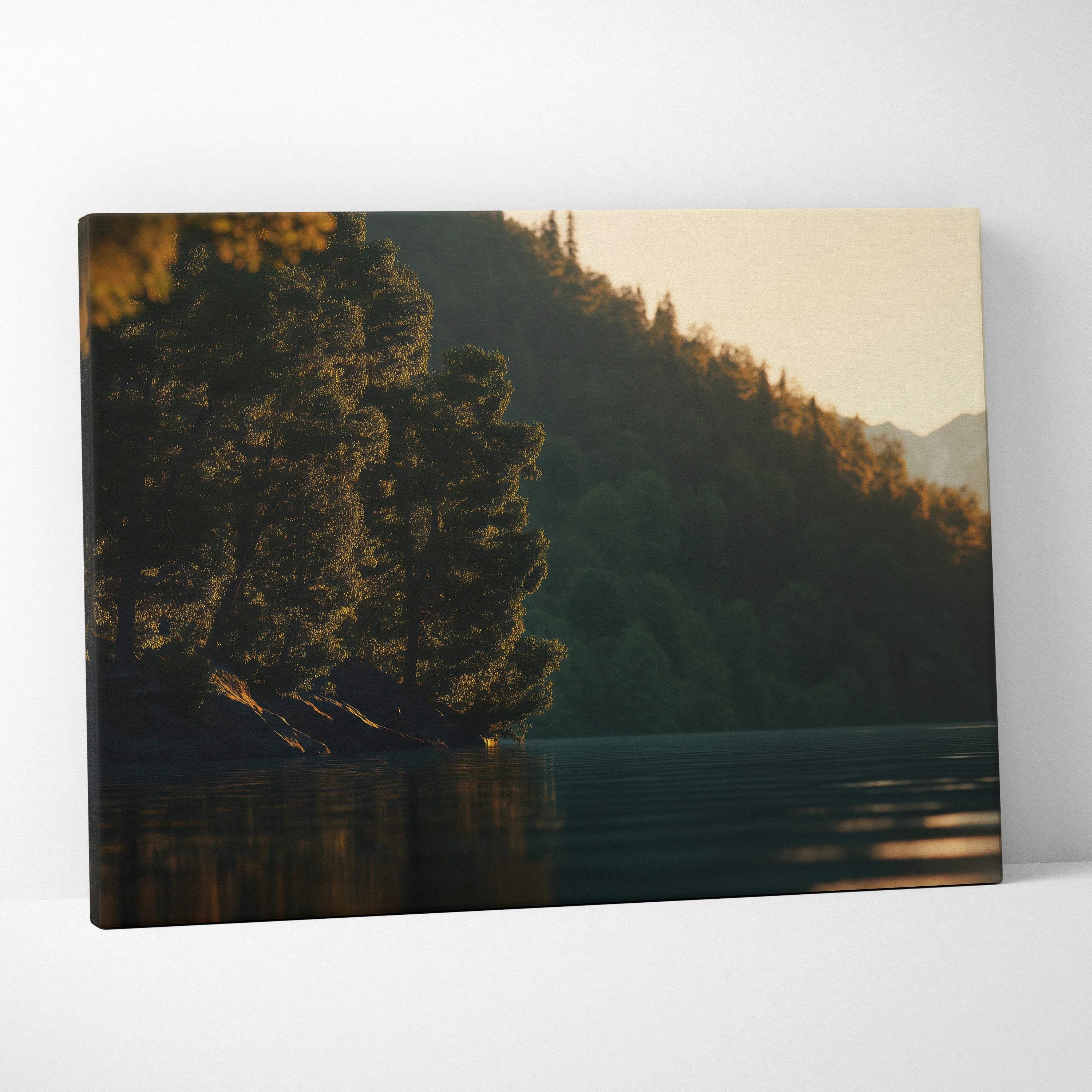 Serene lakeside canvas print with silhouetted trees, mountains, golden sunset on calm water