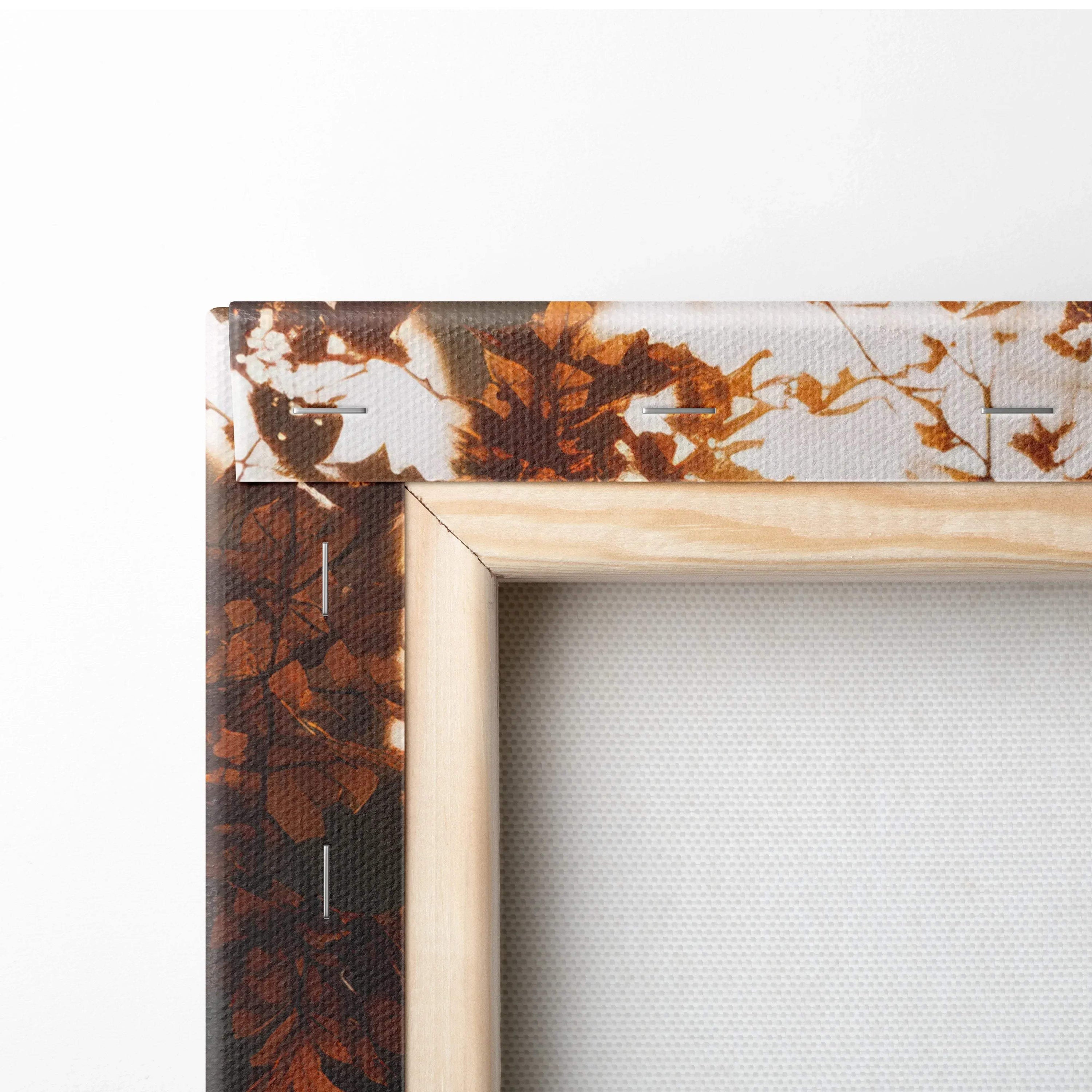 Close-up of stretched canvas art with autumn leaves print and natural wood frame, wall art detail.