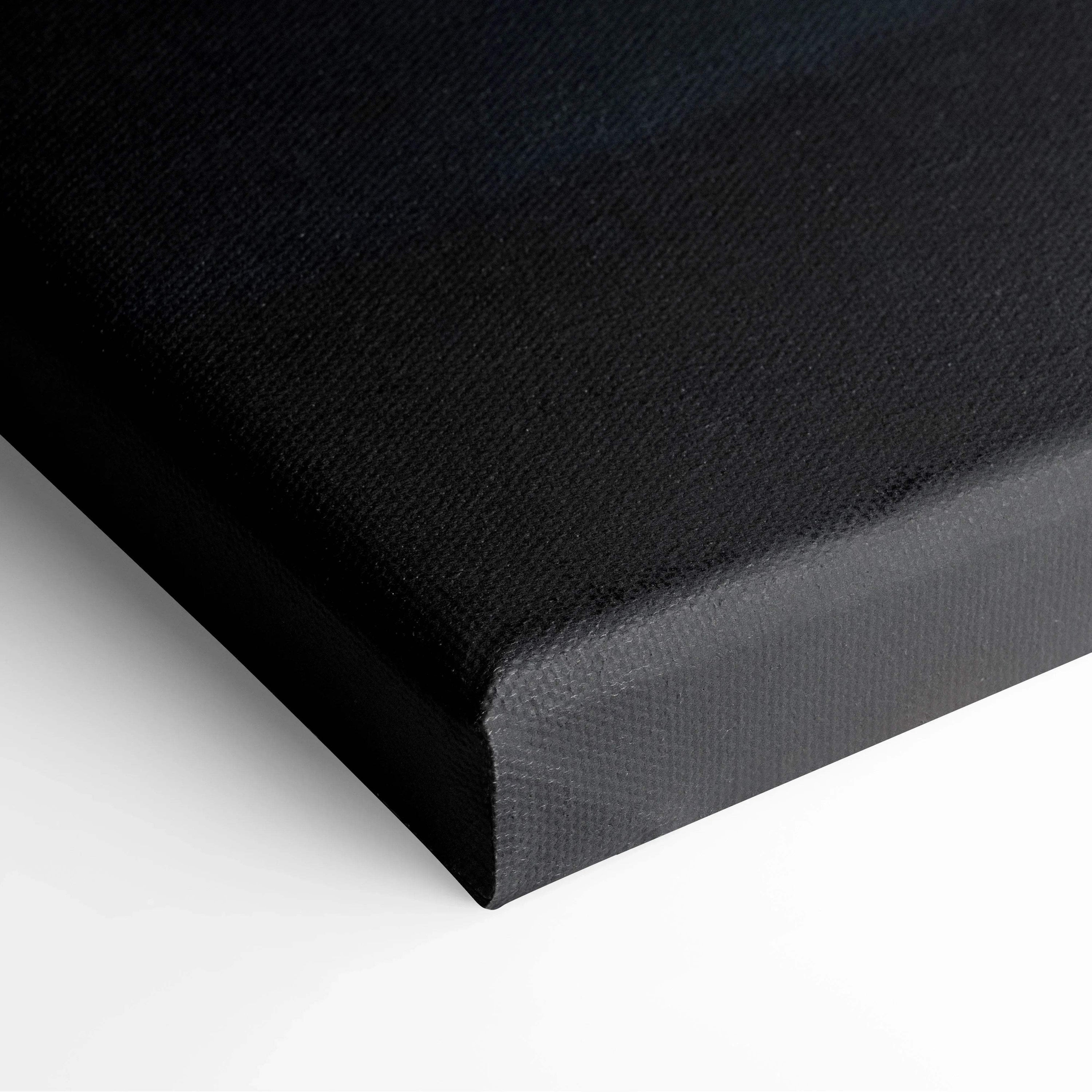 Black gallery-wrapped canvas edge showcasing textured fabric and clean corner fold for wall art.