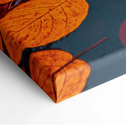 Close-up of autumn leaf detail on canvas wall art with rich orange and blue tones.