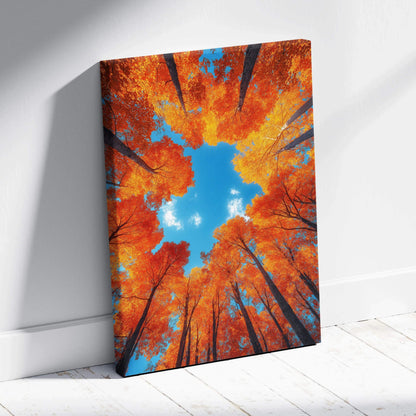 Vertical canvas wall art featuring vibrant orange autumn forest trees with blue sky center.