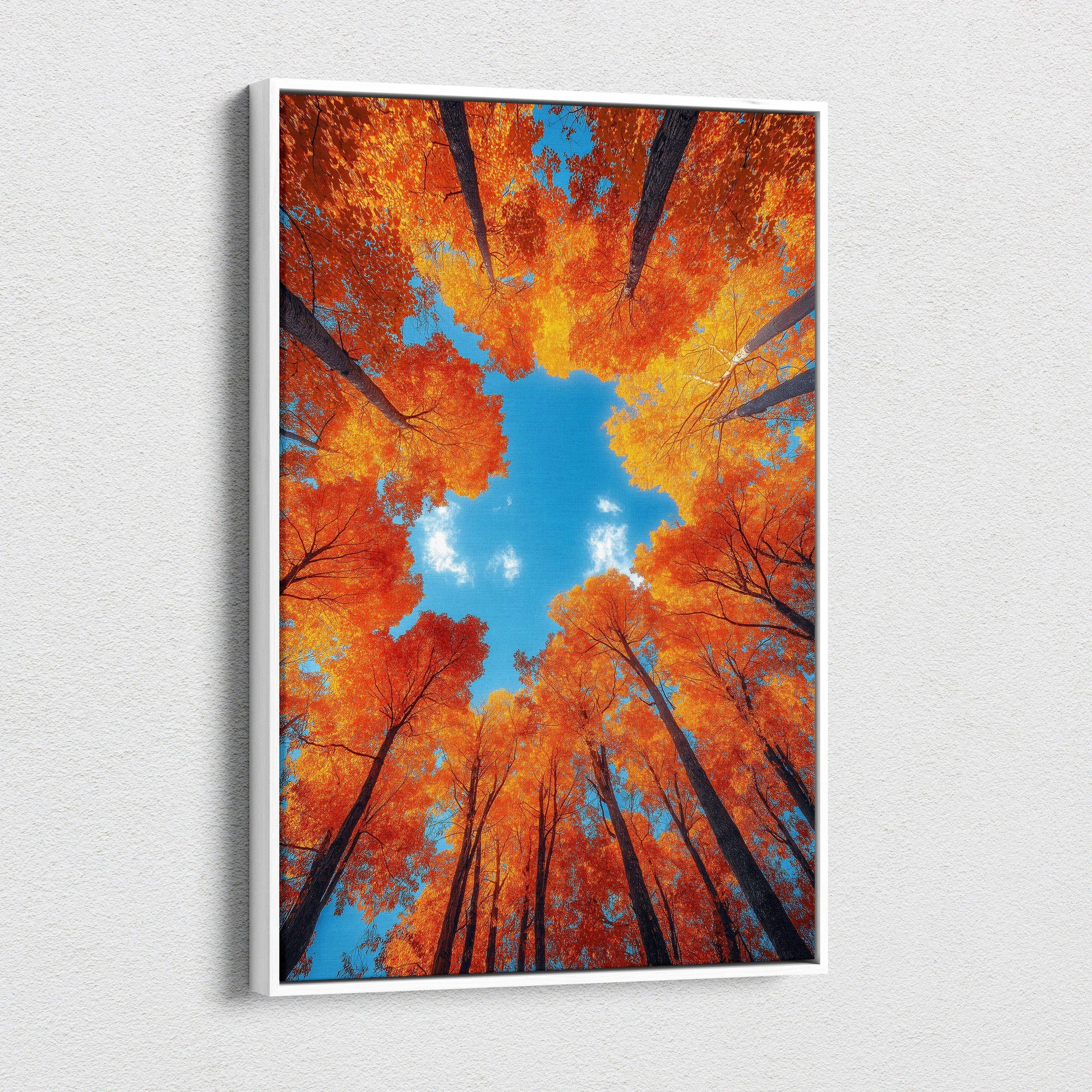 Autumn forest canopy with vibrant orange leaves against blue sky on vertical canvas wall art.