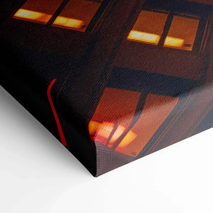 Dark architectural canvas art featuring illuminated windows with warm orange and yellow lights, stretched on frame.