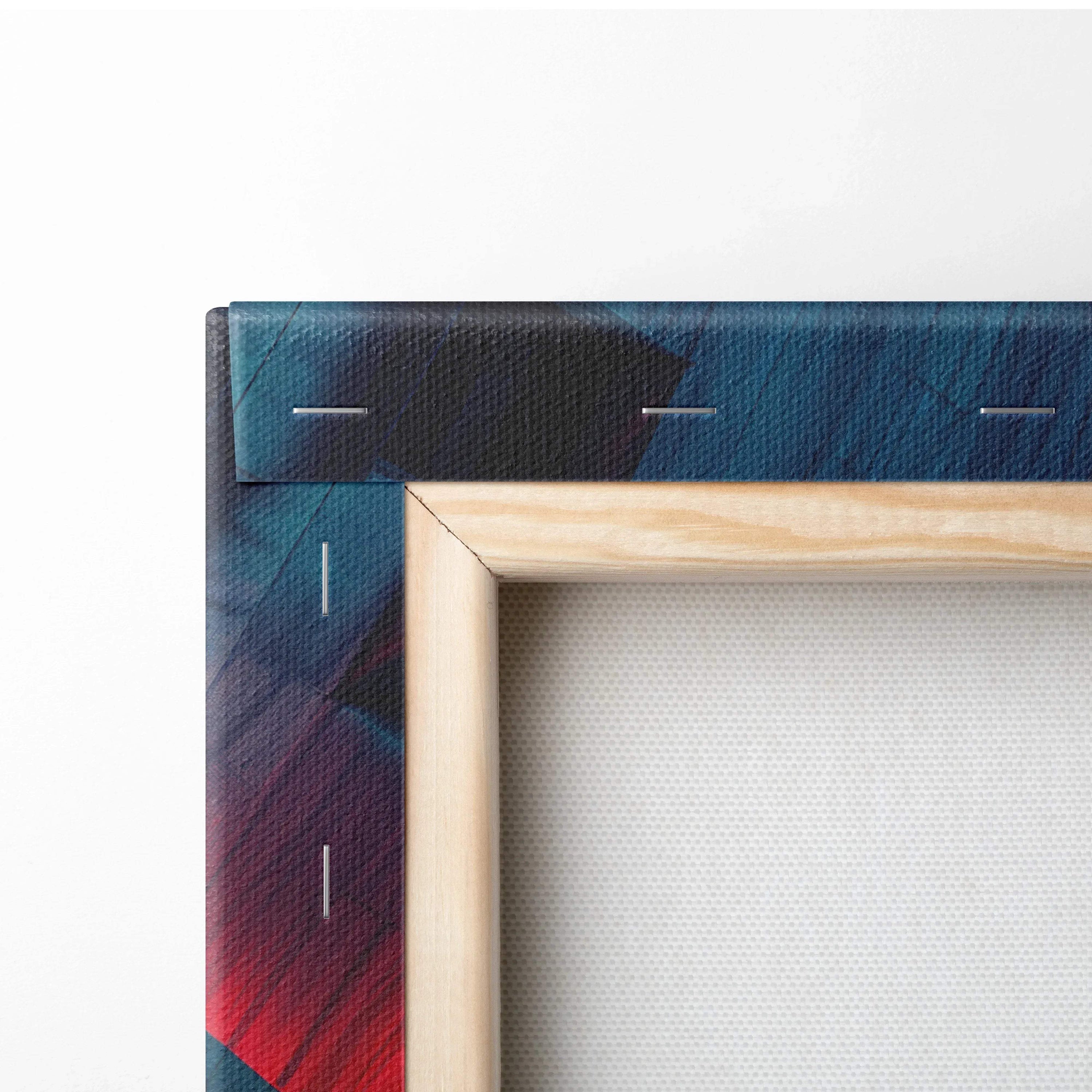 Close-up of wooden stretcher frame with vibrant abstract canvas art in blue, red, and black tones.
