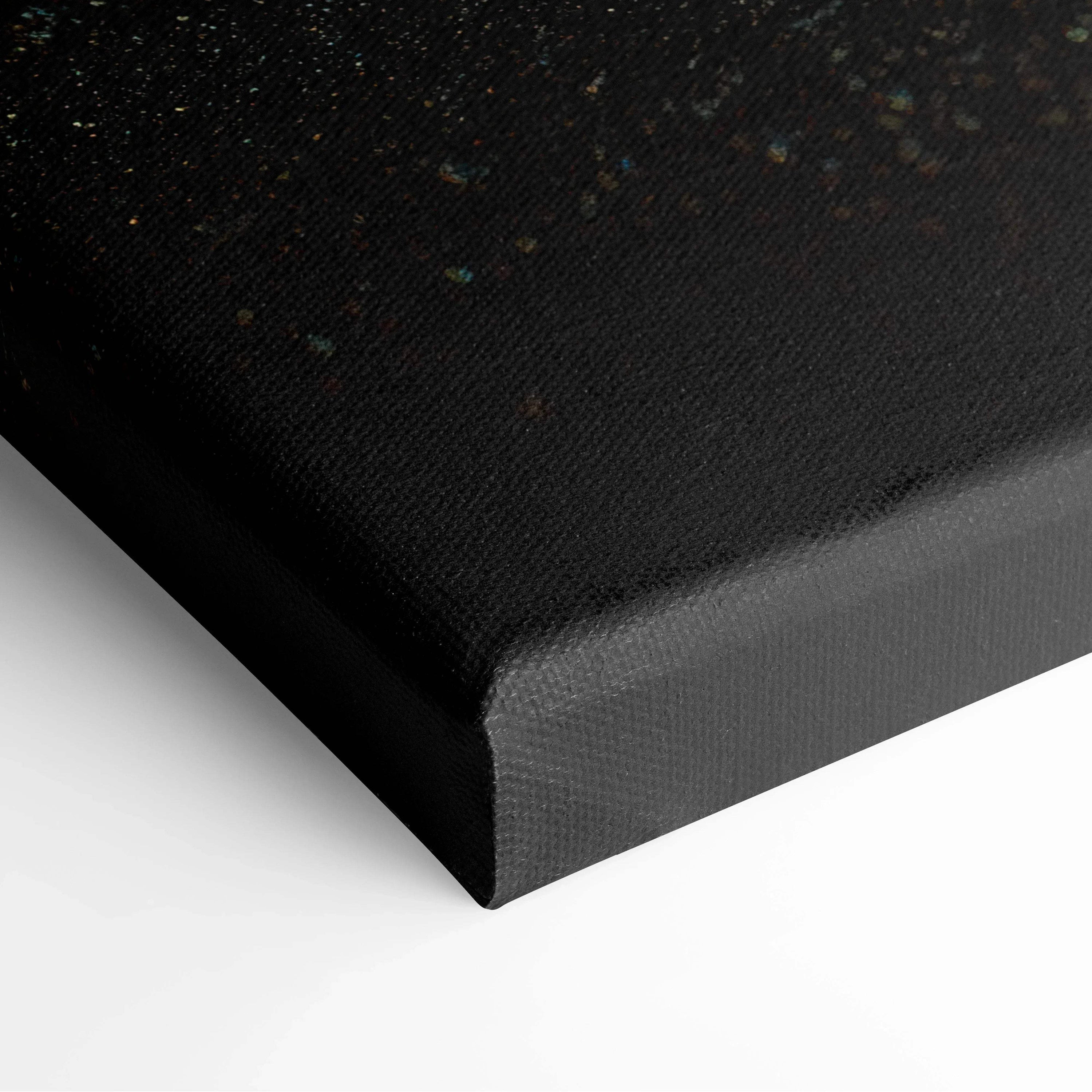 Black canvas stretched over wooden frame with subtle textured surface and small colorful speckles.