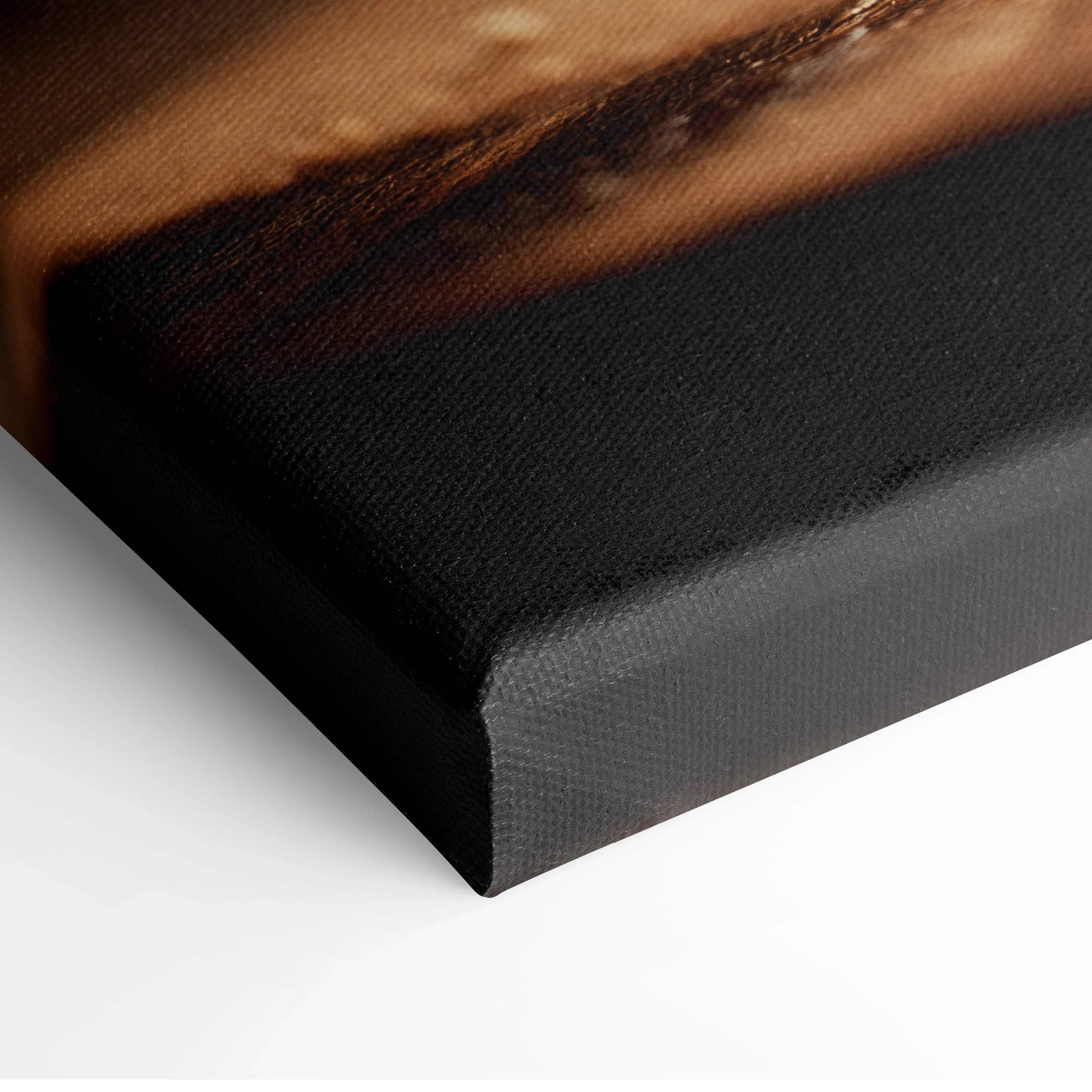 Close-up of black-wrapped edge of hamburger canvas wall art with textured fabric surface.