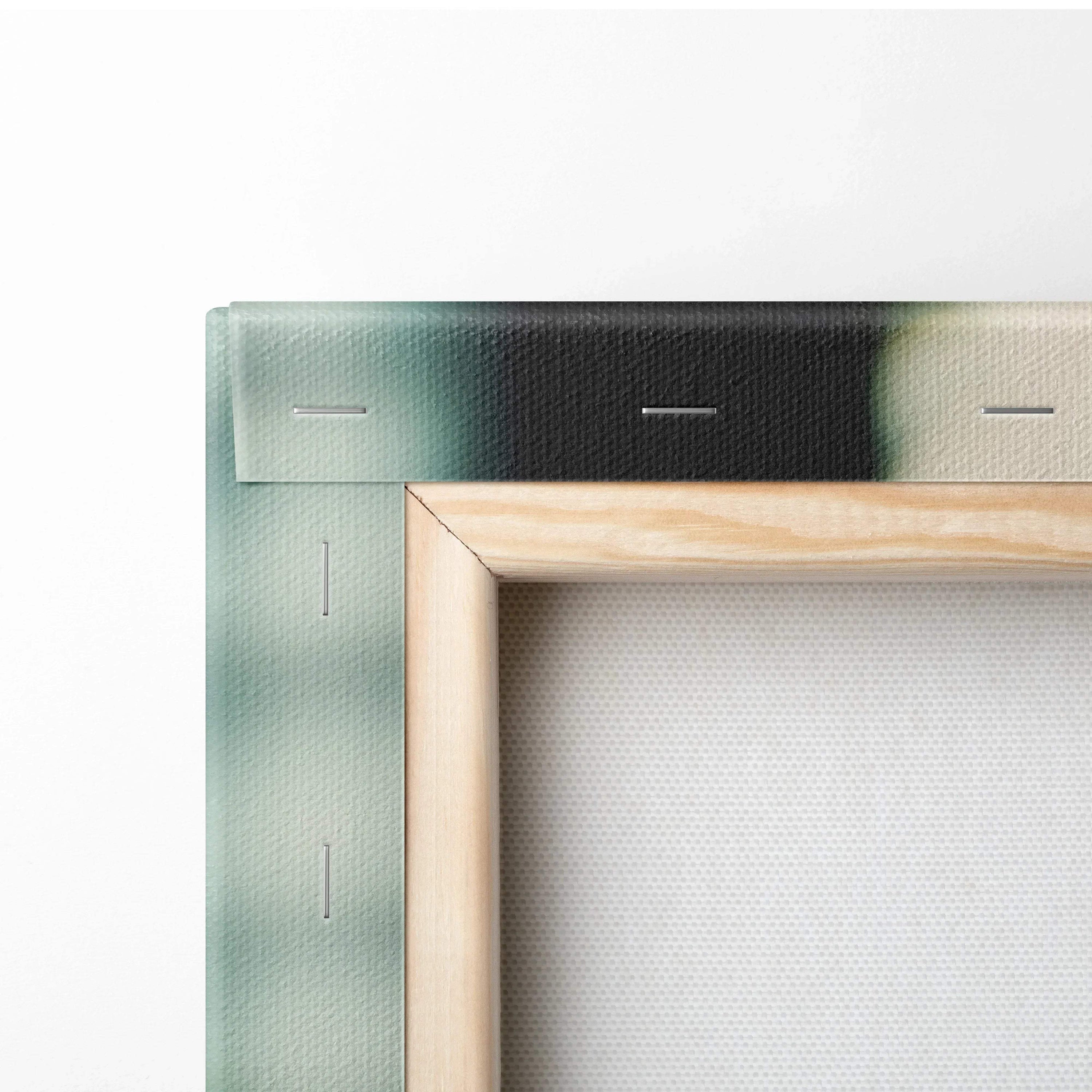 Close-up of wooden frame and stapled edge on canvas wall art decor with green and white printing.