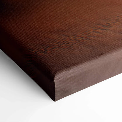 Close-up of brown textured canvas corner with visible fabric weave stretched over wooden frame.