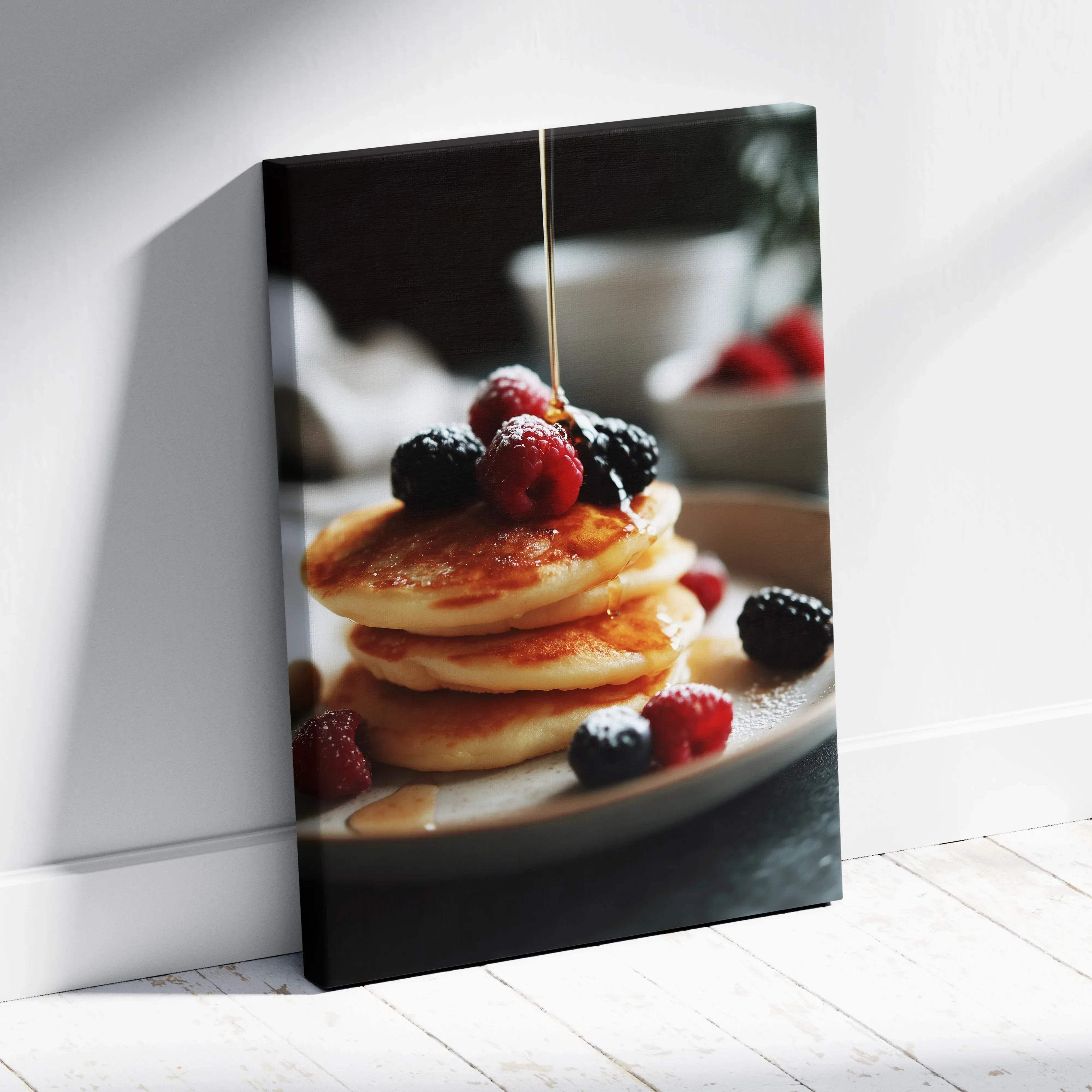 A canvas print featuring golden-brown pancakes with fresh red and black berries drizzled with amber syrup