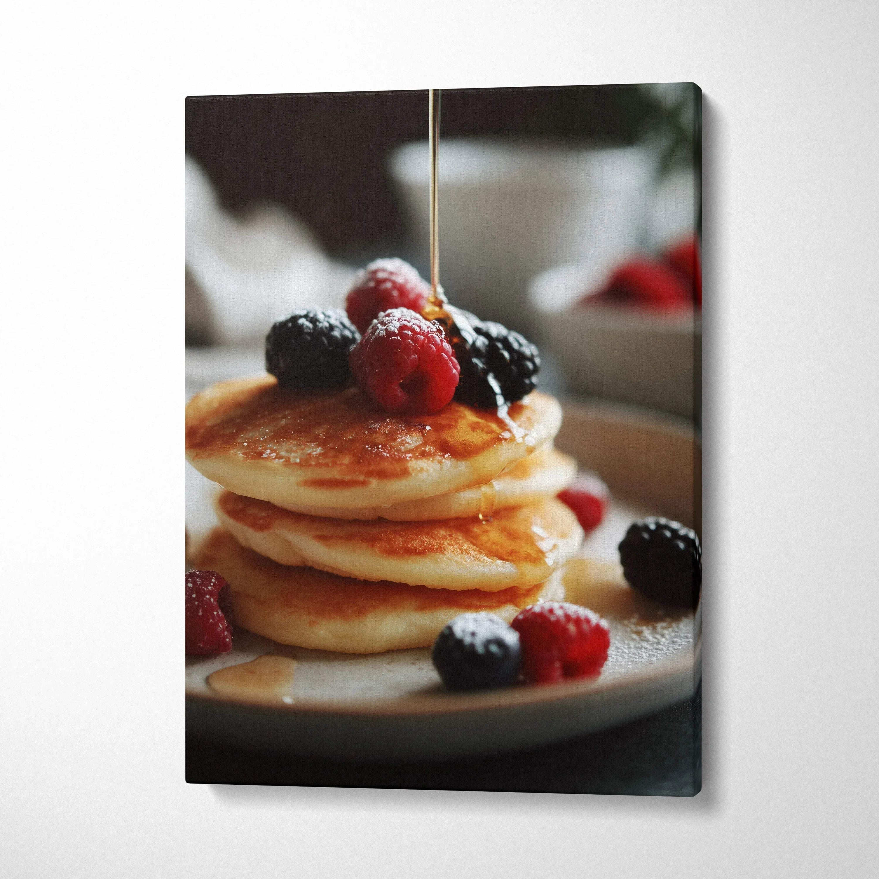 Canvas wall art of golden pancakes topped with mixed fresh berries and honey drizzle for kitchen decor.