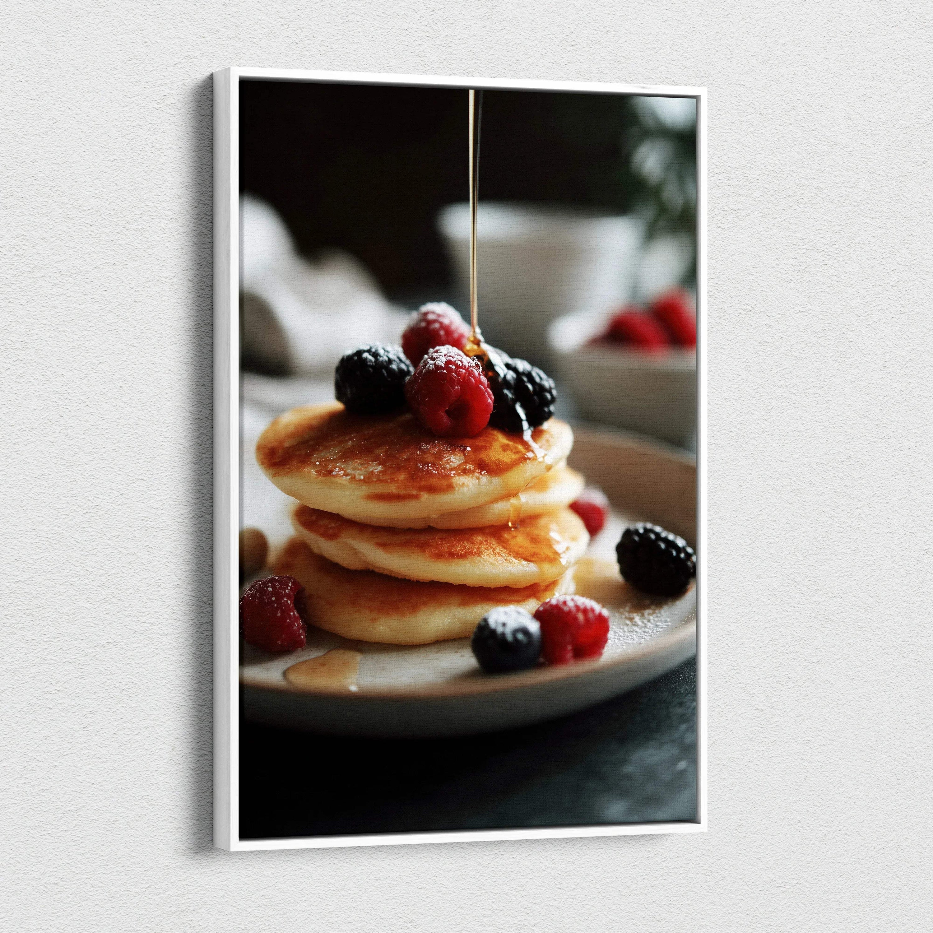 Canvas wall art of golden pancakes topped with fresh raspberries and blackberries with syrup drizzle, kitchen decor.