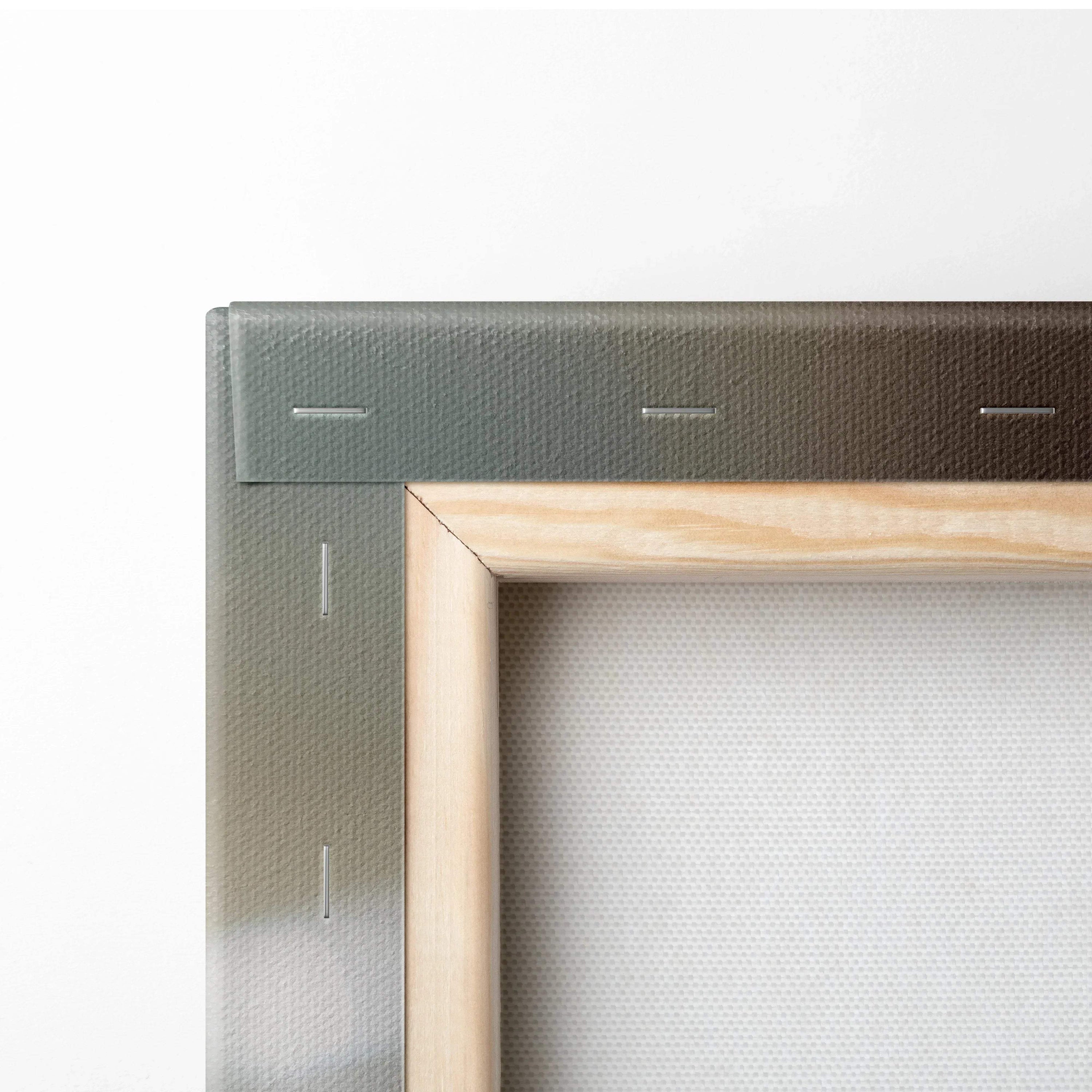 Close-up of stretched canvas corner with natural wood frame and tightly wrapped printed fabric for wall art decor.