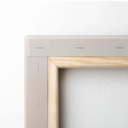 Corner close-up of stretched natural wood frame canvas art with visible white canvas texture and staples.