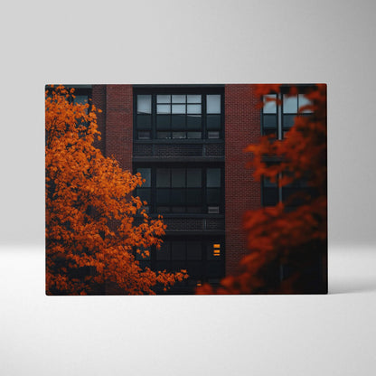 Canvas wall art featuring vibrant orange autumn leaves against dark urban building backdrop with window details.