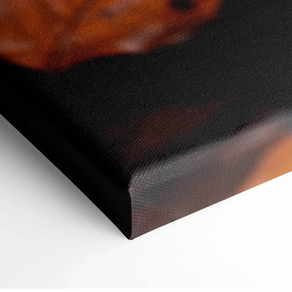 Close-up of minimalist autumn leaves on textured canvas wall art with deep orange and black tones.