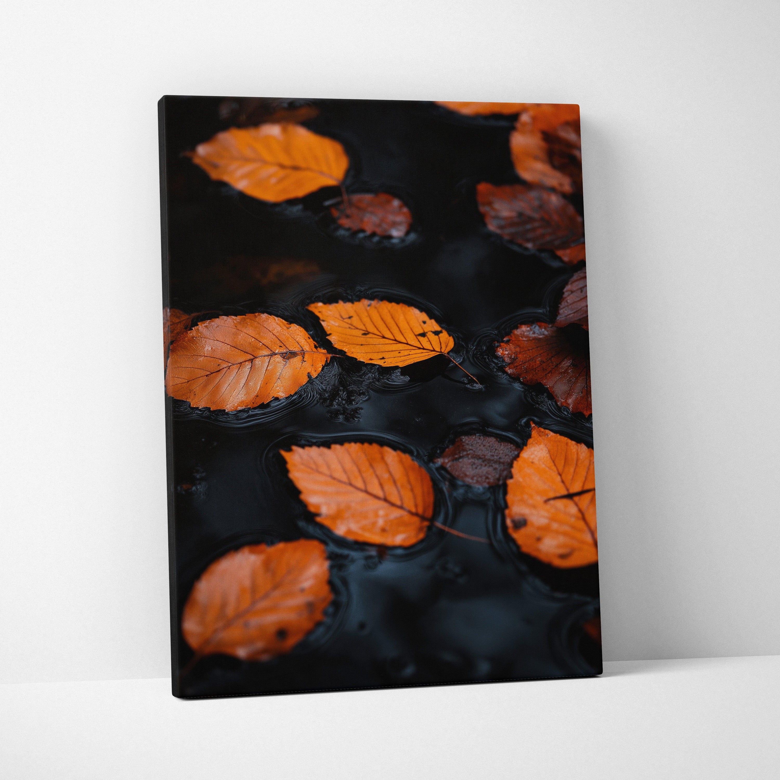 Minimalist autumn nature canvas wall art with orange leaves floating on dark water.
