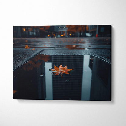 Canvas art featuring a single golden autumn leaf floating on reflective dark water, minimalist wall art with moody earthy.