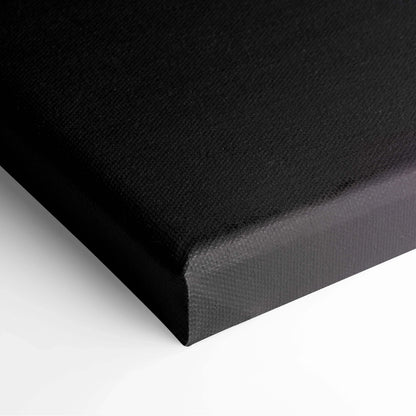 Black gallery-wrapped canvas wall art with textured minimalist surface, corner close-up.