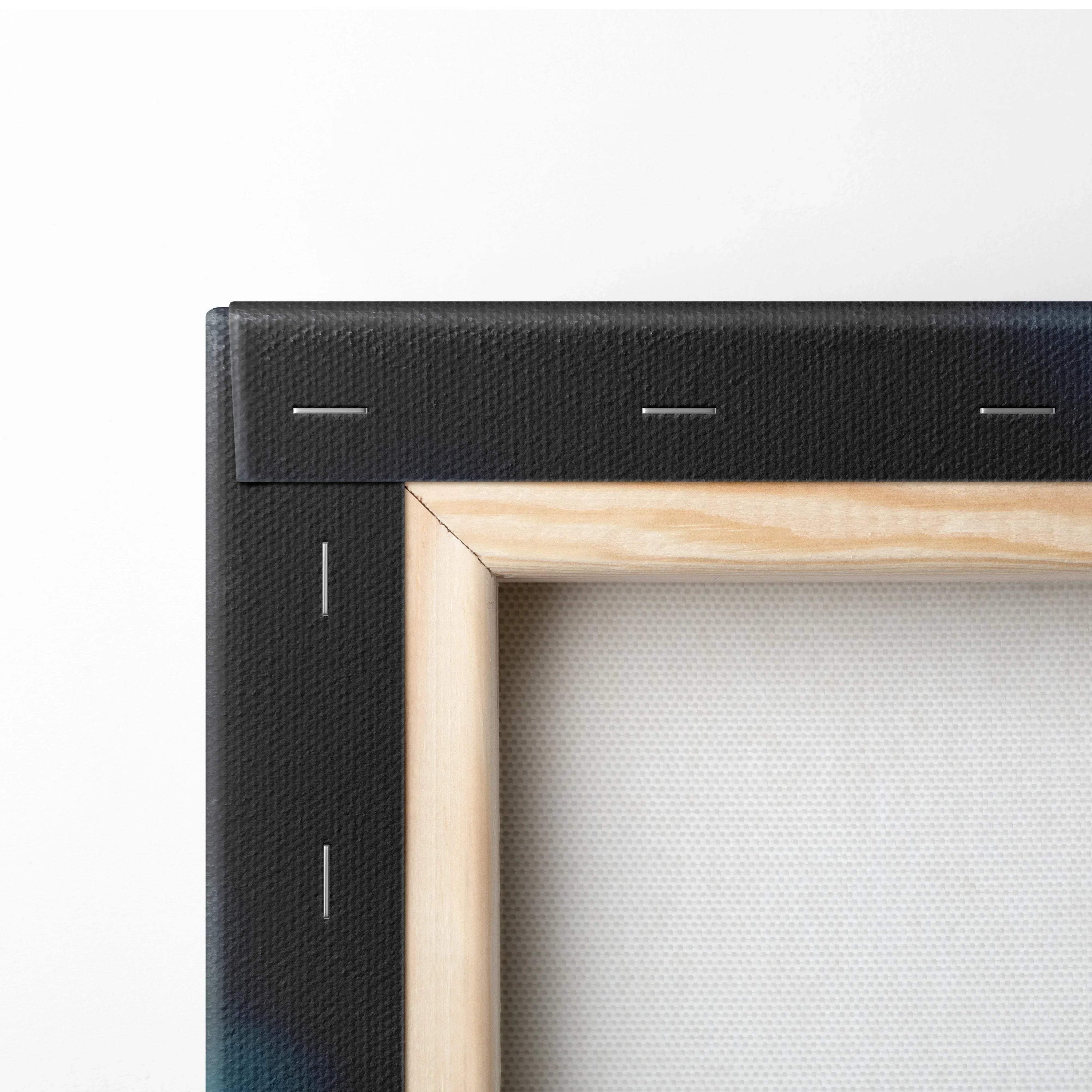 Close-up of stretched canvas fabric on wooden frame with black painted edges for wall art.