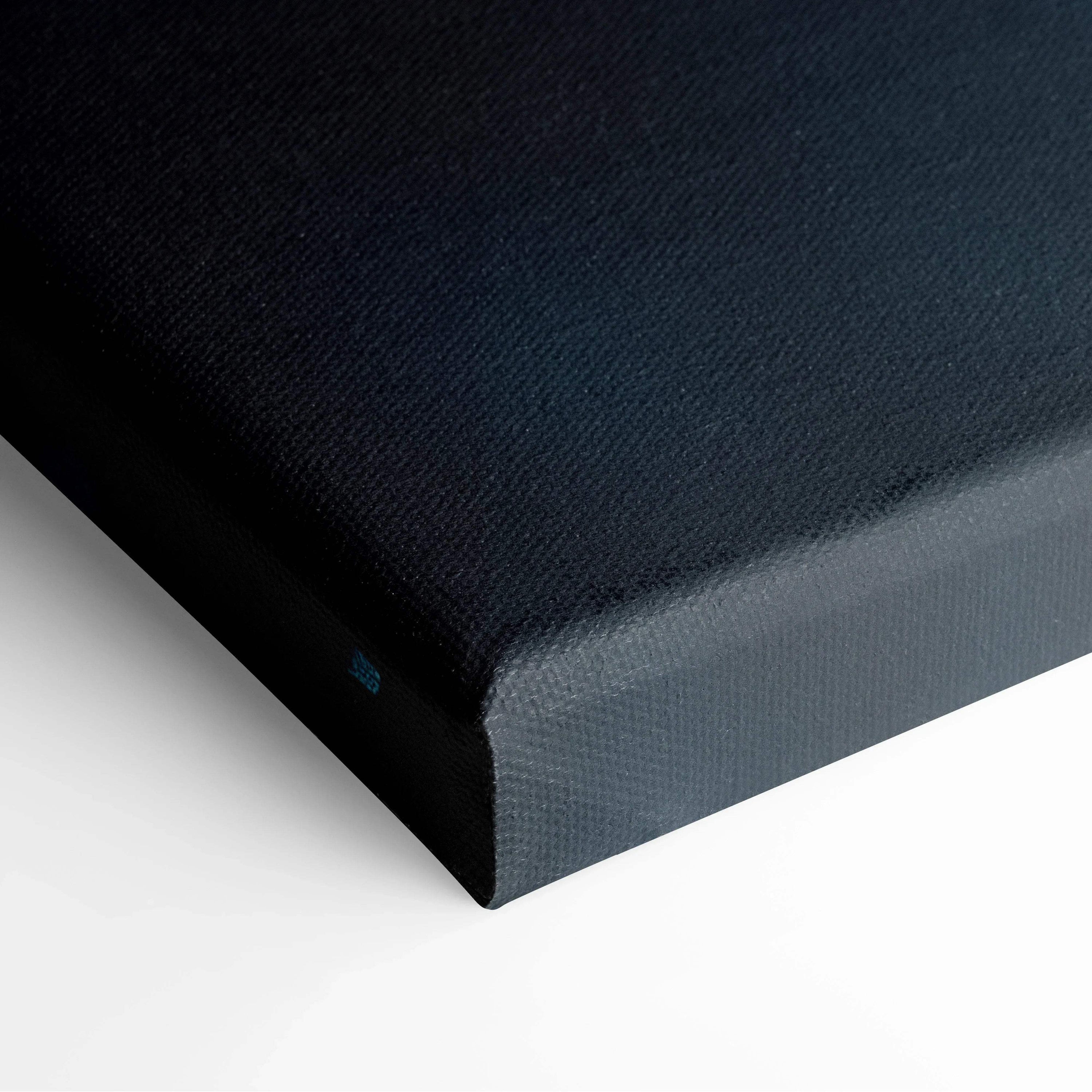 Close-up of black canvas wall art with minimalist texture on stretched frame edge.
