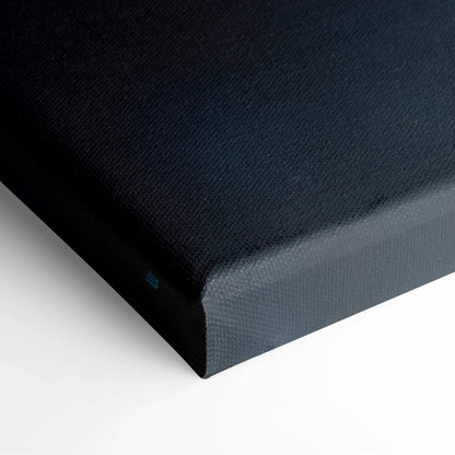 Close-up of black canvas wall art with minimalist texture on stretched frame edge.
