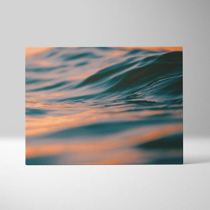 Digital art canvas wall art showing tropical ocean waves at golden hour sunset with warm orange and blue tones decor.
