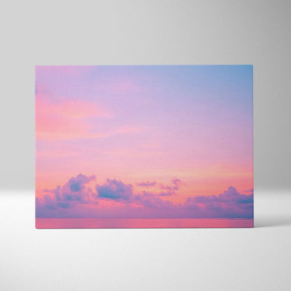Canvas wall art with a tropical ocean scene featuring pink and purple clouds at sunset.